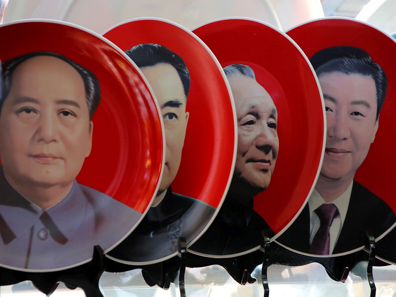 FILE PHOTO: Souvenir plates featuring portraits of current and late Chinese leaders Xi Jinping, Deng Xiaoping, Zhou Enlai and Mao Zedong are displayed for sale at a shop in Beijing